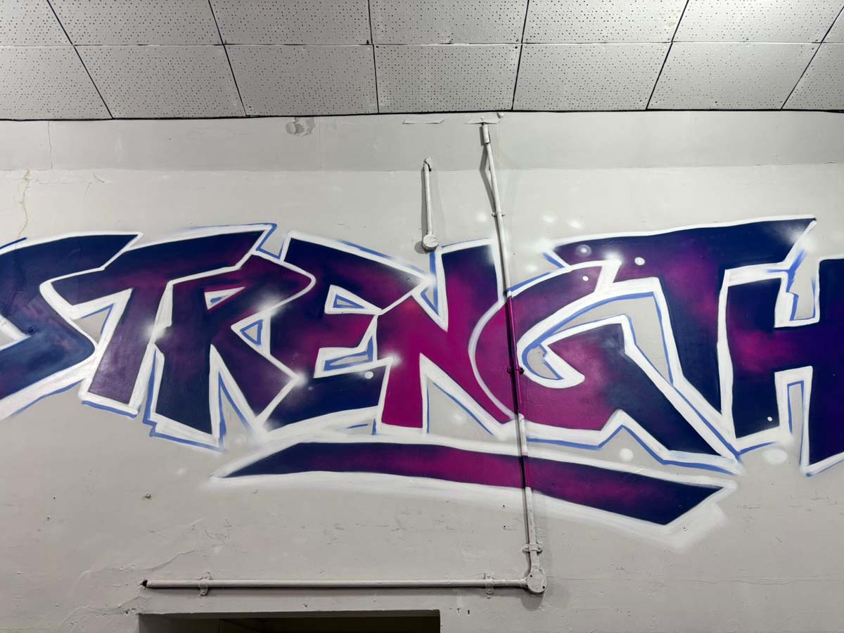 Strength graffiti artwork on the B-Strong gym wall