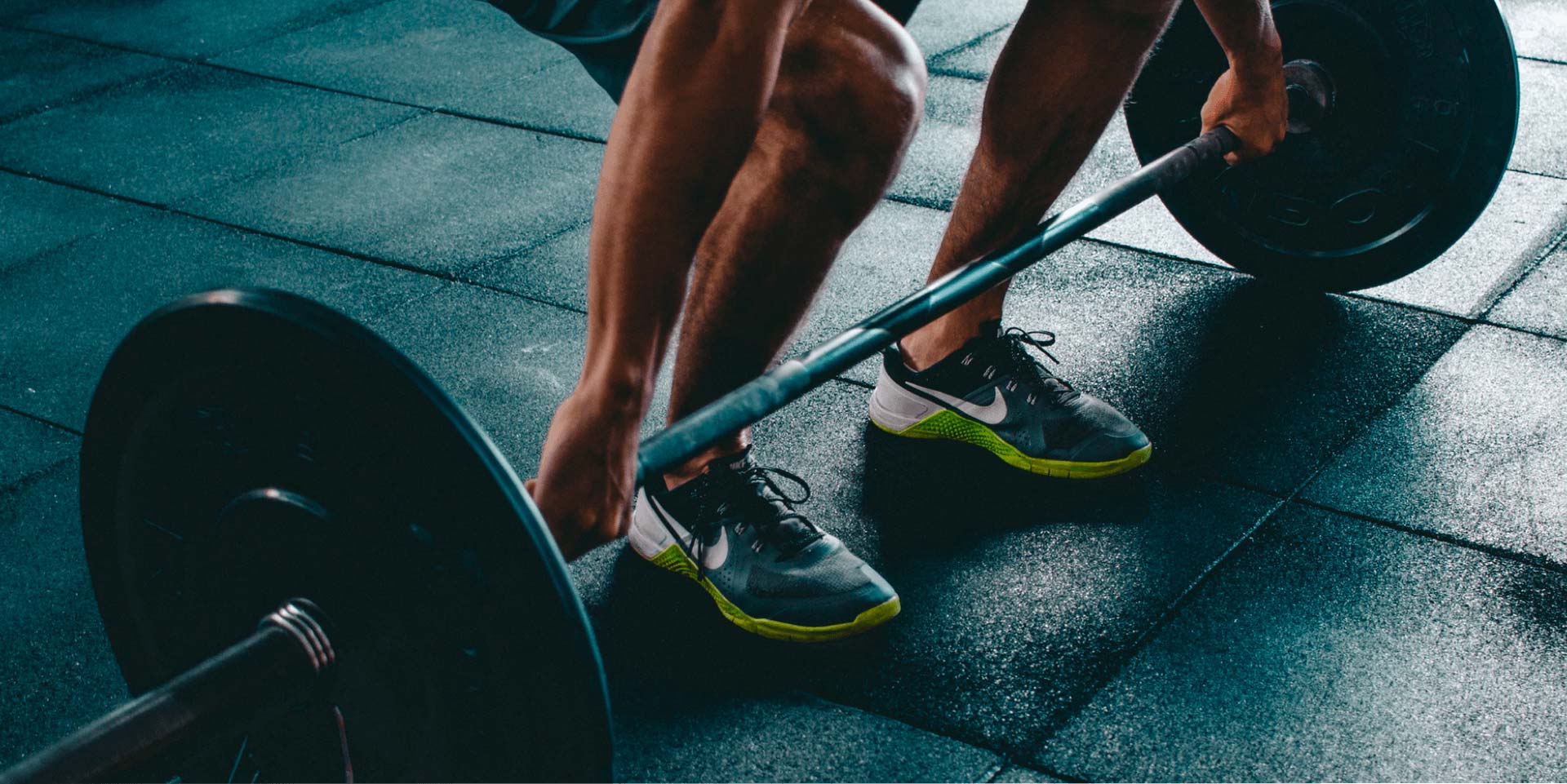 Close-up of a barbell being lifted from the floor