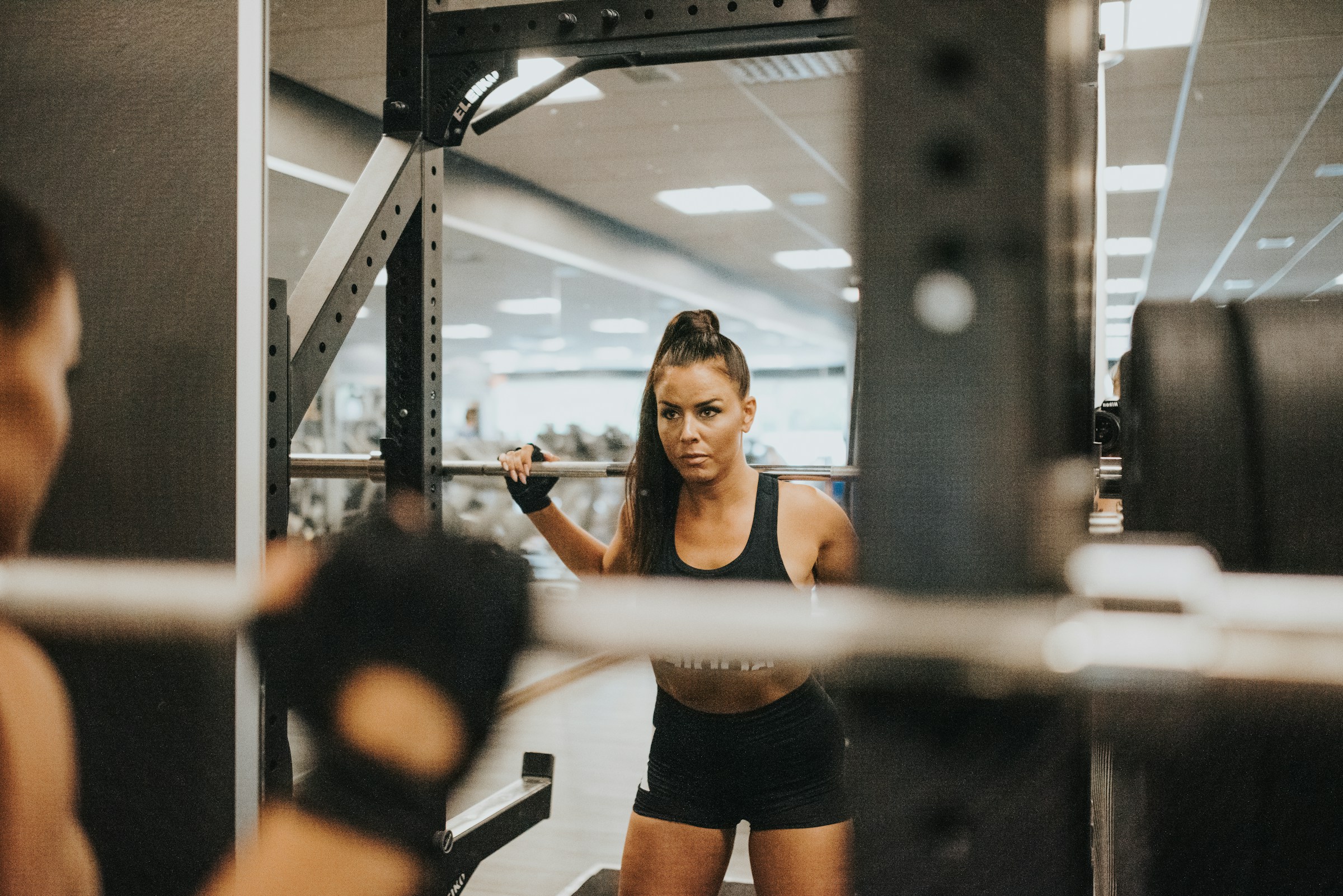A member training alone in a crowded commercial gym
